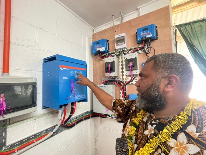 MP Jean Jacques Ngwele switching on inverter to establish power at Nduindui Heolth Centre