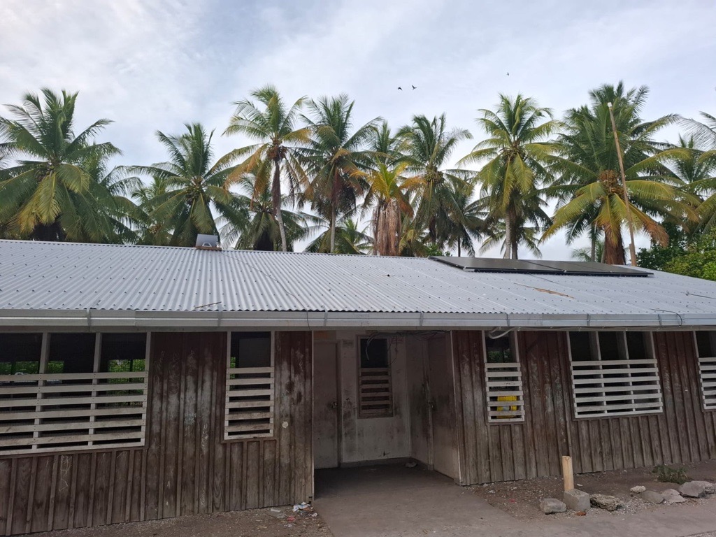 The project installed solar-powered battery systems and solar water pumps across all five communities on the island, powering three schools and five community halls